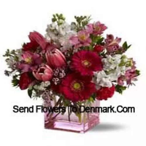 Red Roses, Red Tulips And Assorted Flowers With Seasonal Fillers Arranged Beautifully In A Glass Vase