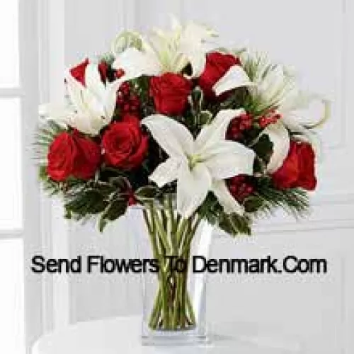 Fulfill their dreams for a glimpse of the season's inspired beauty. Rich red roses dazzle and delight when arranged with snowy white Oriental lilies accented with assorted holiday greens and variegated holly stems in a clear, sculpted glass vase. This bouquet offers them a warm wish for a lovely holiday season they will always hold dear. (Please Note That We Reserve The Right To Substitute Any Product With A Suitable Product Of Equal Value In Case Of Non-Availability Of A Certain Product)