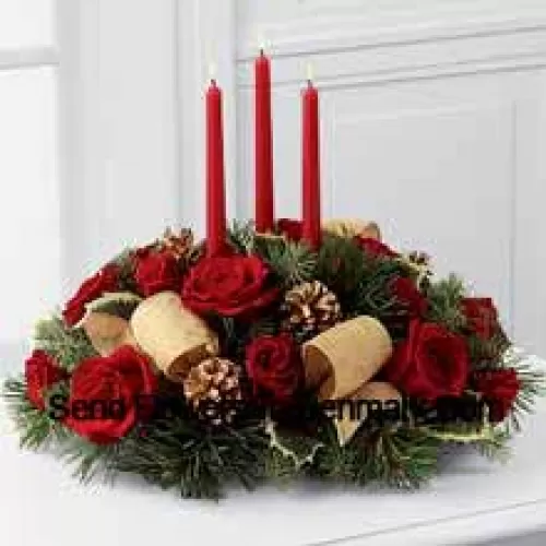 This Centerpiece is a grand display of holiday elegance. Red roses and spray roses pop against a backdrop of assorted holiday greens and variegated holly that beautifully encircle three red taper candles. Accented with gold pinecones and gold metallic brocade ribbon, this centerpiece creates a warm and enchanting glow to benefit their holiday festivities. (Please Note That We Reserve The Right To Substitute Any Product With A Suitable Product Of Equal Value In Case Of Non-Availability Of A Certain Product)